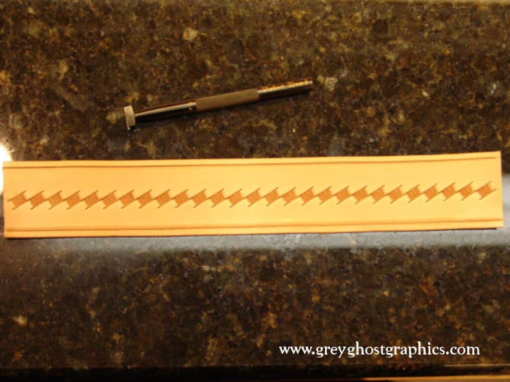 The centerline of the strap is stamped with the basket stamp.